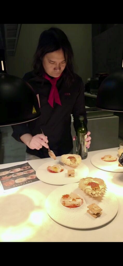 Chef Capper plating Spanish fine dining dishes at SÓPA Restaurant Bangkok